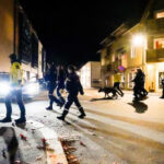 A night image on Norway street with police and a dog. Giving the sense of rise in crime.