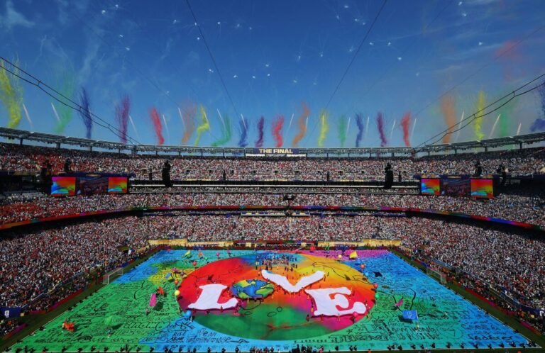 FIFA World Cup 2026 stadium filled with fans during opening ceremony featuring large LOVE banner on the field